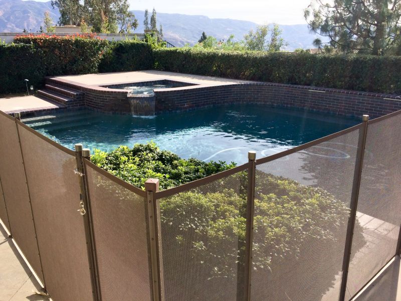 Removable Mesh Fence Secured at Pool Edge